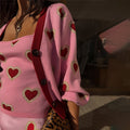 Pink Hearts Cardigan in a soft knit with red heart motifs and contrast red ribbed trims over a matching top.