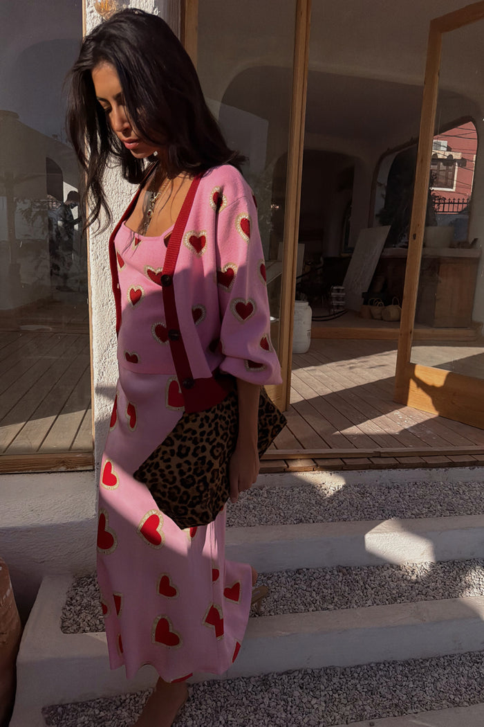Pink Hearts Cardigan featuring red heart motifs and contrast trims, paired with a matching heart print skirt.