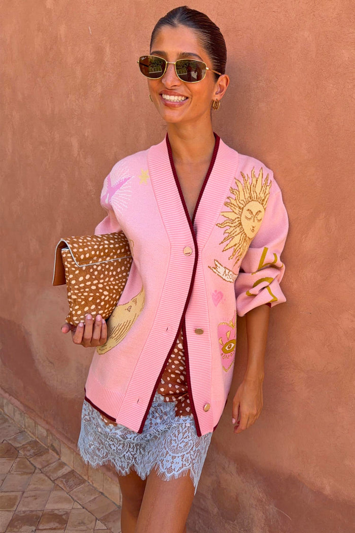 Pink Mystical Cardigan with sun and moon jacquard motifs, burgundy contrast trims and button-up fastening.