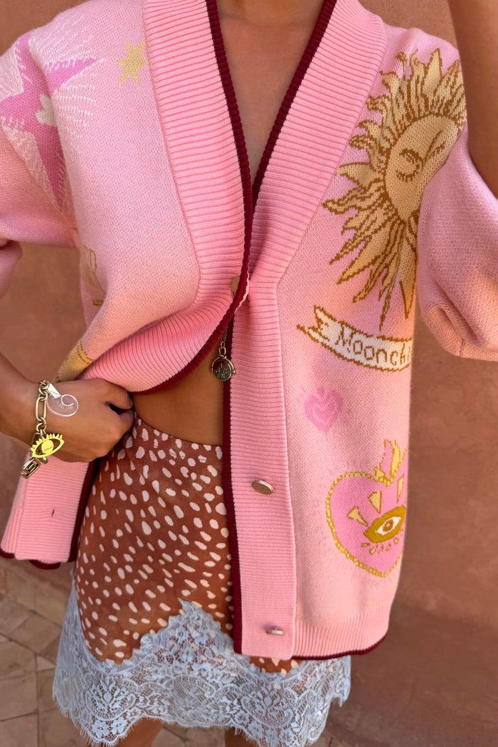 Pink Mystical Cardigan with sun and moon jacquard motifs, burgundy trims and a transeasonal soft knit finish.