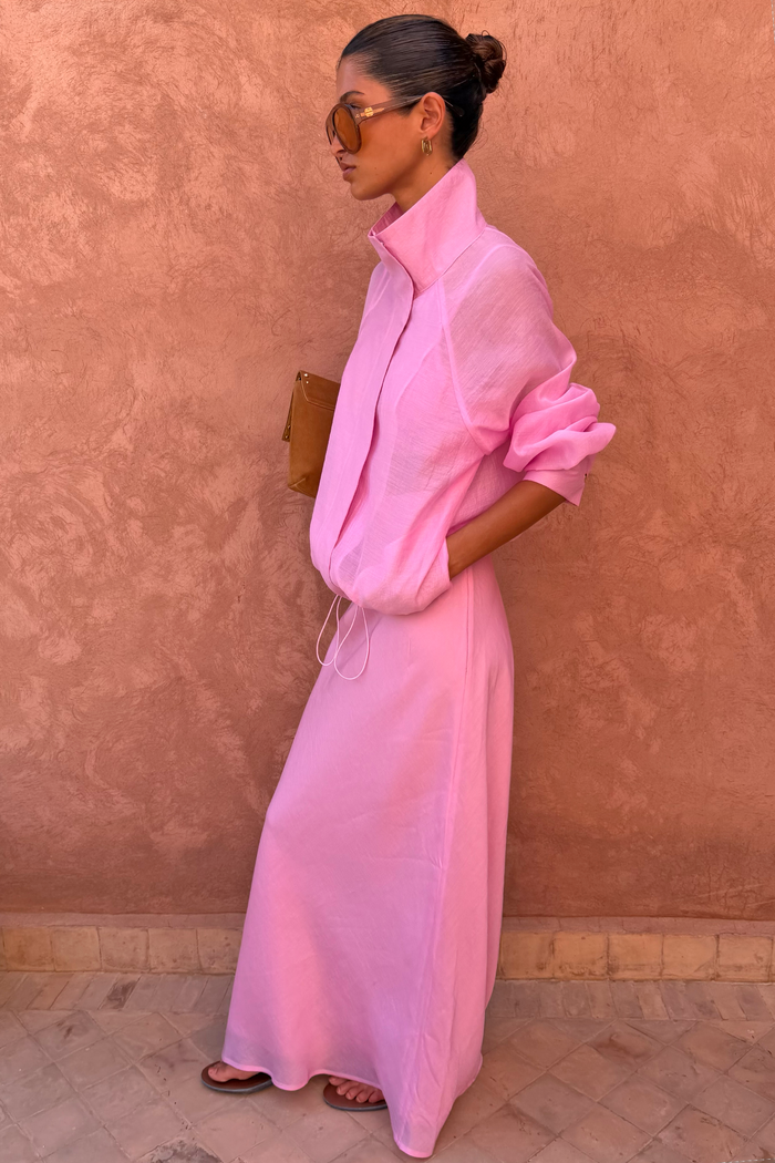 Sheer Pink Organza Funnel Jacket and matching maxi skirt styled against a textured terracotta wall.