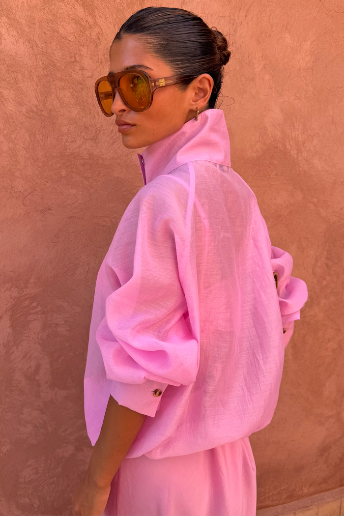 NFD Pink Organza Funnel Jacket in sheer fabric with a statement high collar, shown in profile on a model.