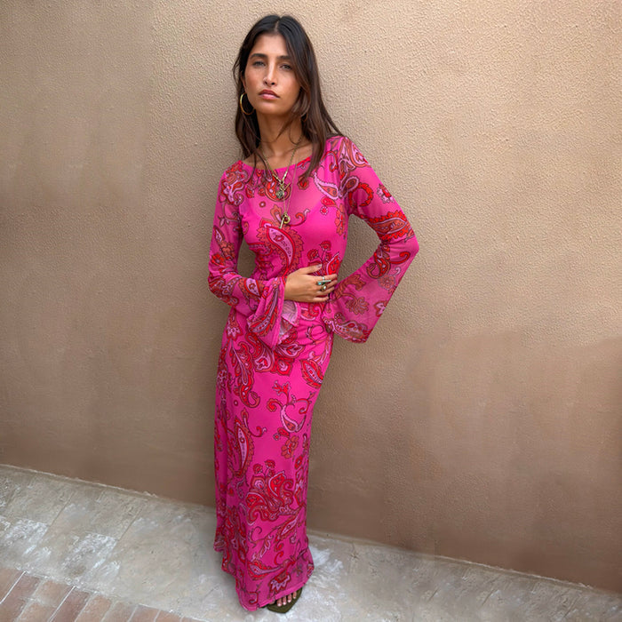 Pink Paisley Mesh Dress featuring long flared sleeves and a bright paisley print, styled with gold jewellery.