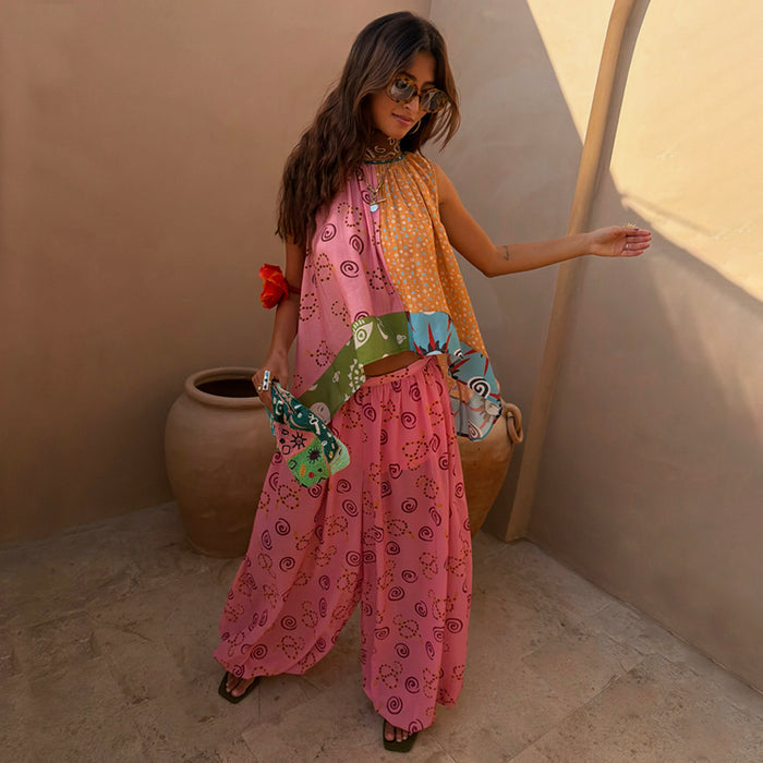 Pink Snake Balloon Trouser in dusky pink with swirl motifs, paired with a matching co-ord top in a sunlit courtyard.