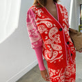 Red Bandana Martha Cardigan in a soft pink and red paisley knit with black buttons and puffed sleeves.
