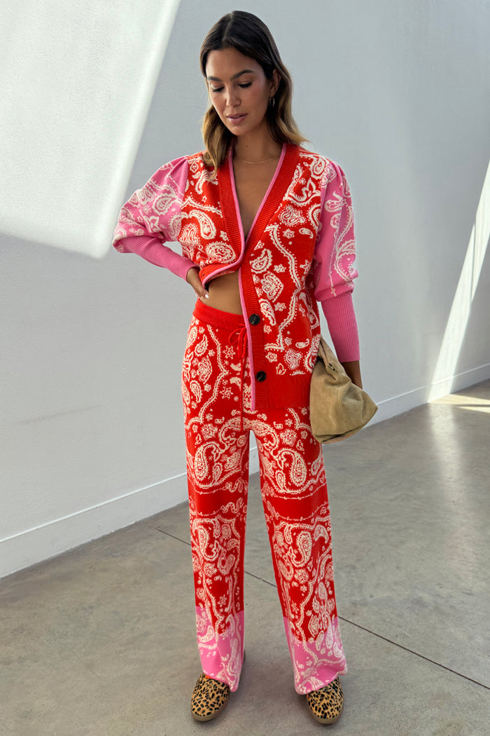 Red Bandana Martha Cardigan with a red and pink bandana print, worn as a co-ord with matching knit trousers.