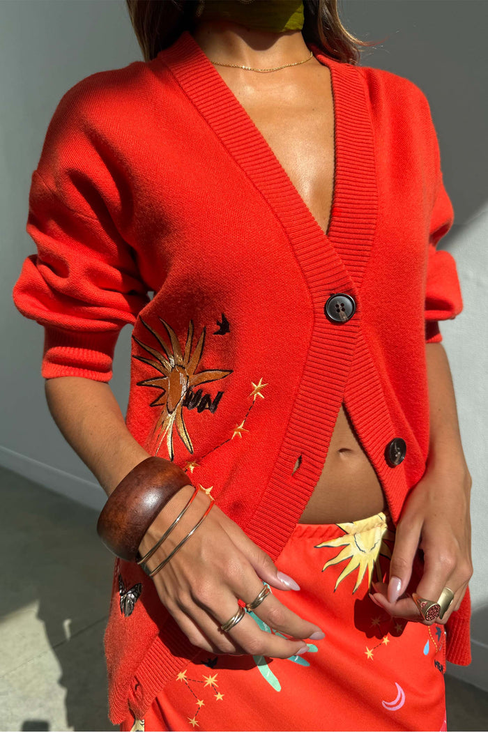 Red Celestial Cardigan featuring sun and star embroidery, button-up front, styled with the matching Dorris skirt.