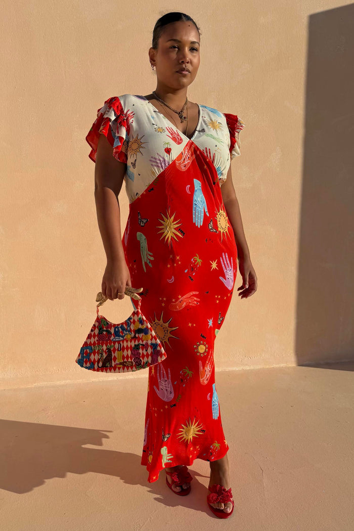 Red Celestial Midi Dress with a v-neck blouson top and iconic celestial motifs, shown for inclusive sizing.