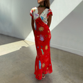 Red Celestial Midi Dress featuring a V-neckline and colourful sun and hand motifs on a cream and red viscose base.