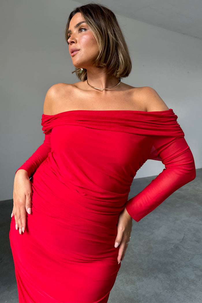 Red Diaz Dress in ruched mesh with a bardot neckline, worn by a model in size UK 18 / US 14.