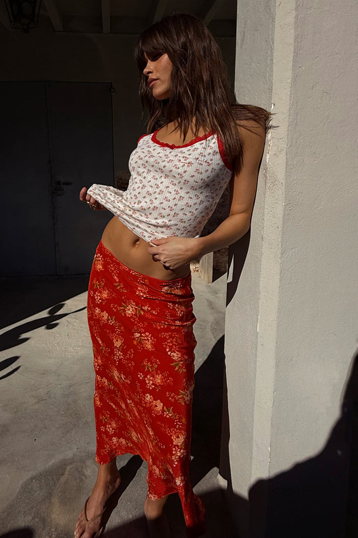 Red Floral Midi Skirt with a floral print, paired with a white pointelle vest for a vacation look.