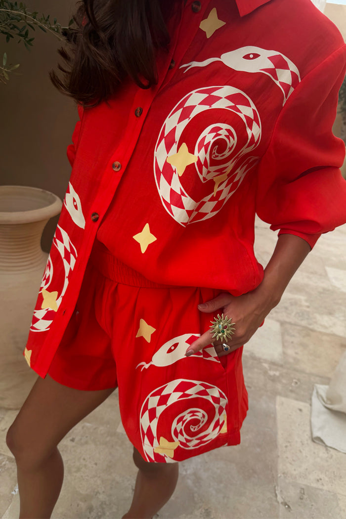 Red Snake Elissa Shorts and Miley shirt co-ord with checkered snake motifs and stars in a bright red tone.
