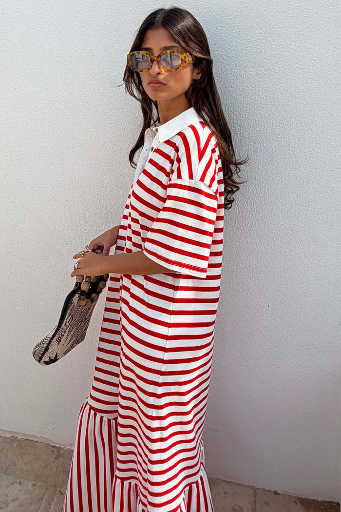 Red Stripe Jersey Dress with a white collar and asymmetric skirt, styled with tortoiseshell sunglasses.