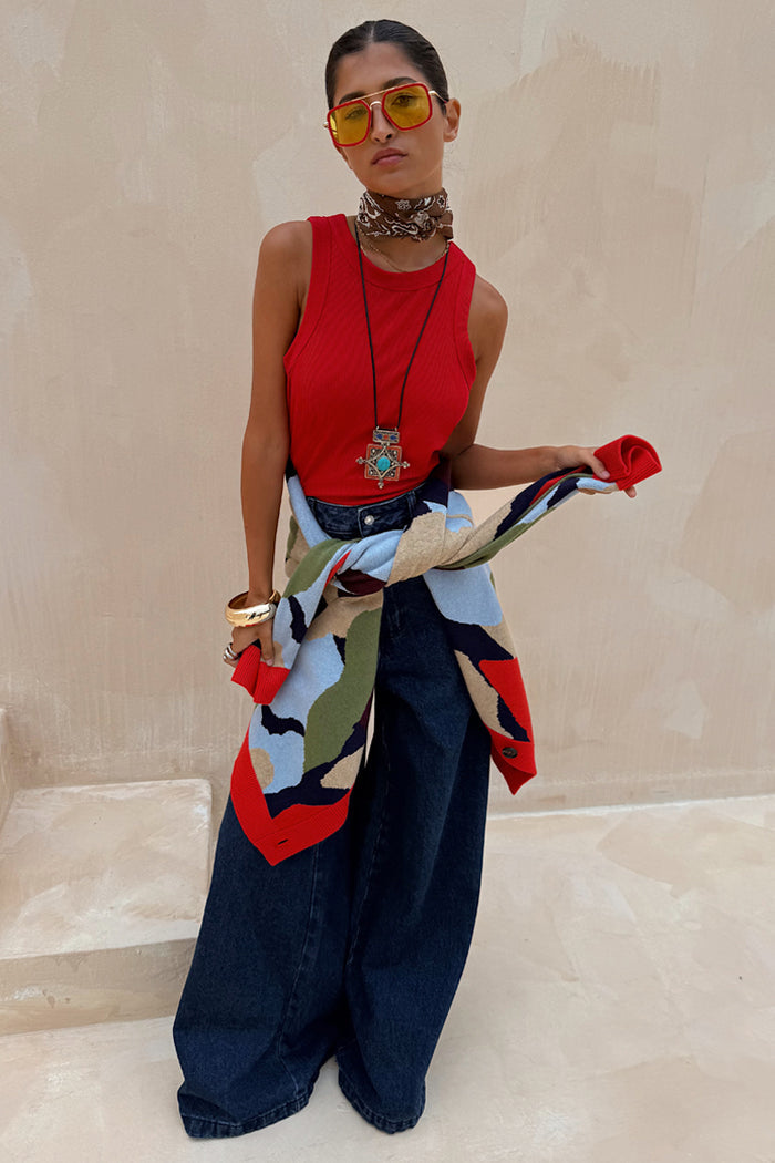 Red Ribbed Tank Top wardrobe staple styled with wide-leg jeans and a patterned cardigan for a London look.