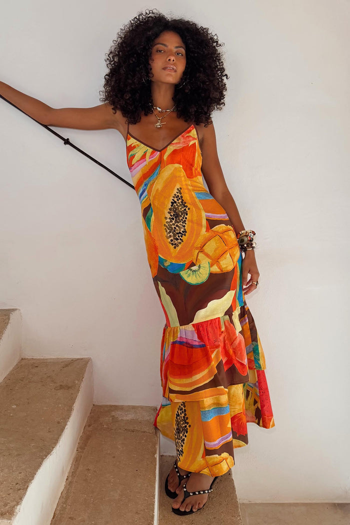 Rio Laragh midaxi dress in a tropical papaya cotton-linen print with a tiered hem, shown on a model.