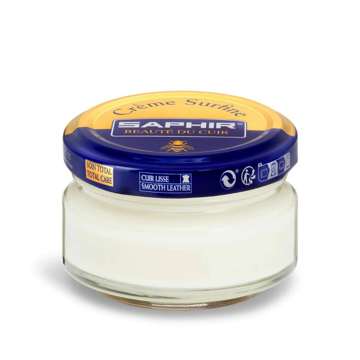 A jar of Saphir Creme Surfine shoe polish with a label on the lid.