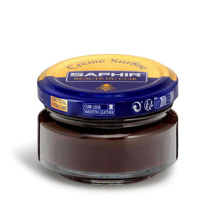 A jar of Saphir Creme Surfine shoe polish with a label on the lid.