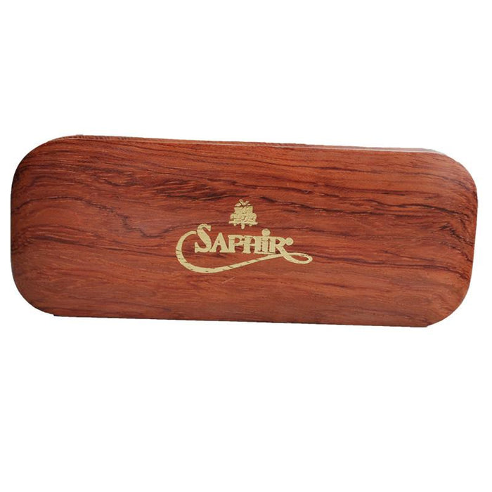 A crepe suede brush with a beige bristle head and a brown exotic wood handle.
