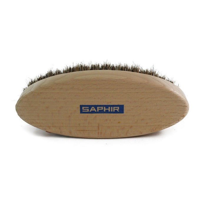 An oval shoe shine brush with horsehair bristles, with natural brown bristles, wooden handle, on a white background.