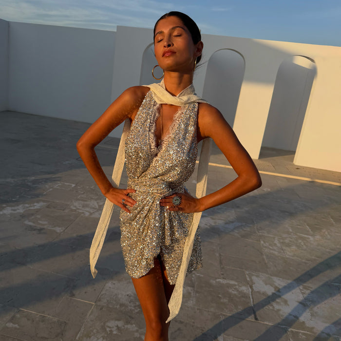 Silver Sequin Lily Top with delicate lace ties and matching Jaspre skirt, worn by a model in golden hour light.