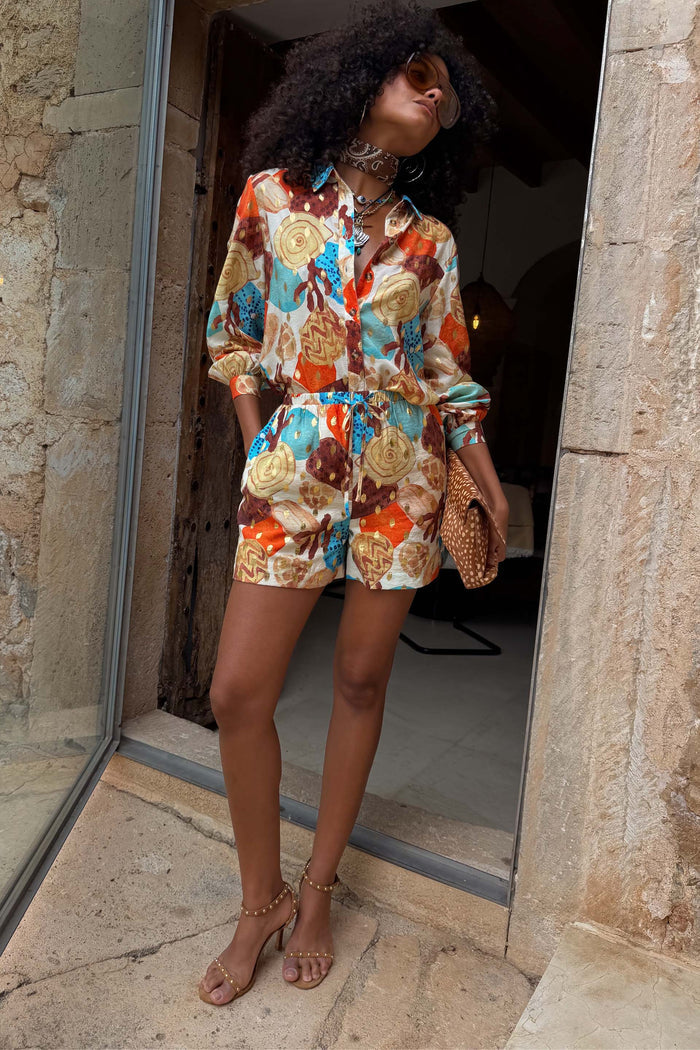 Shell Marley Shirt with a multi abstract shell print and metallic detailing, styled as a co-ord with matching shorts.
