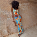Shell Ribbed Skirt with a blue hand-painted shell print, worn as a maxi co-ord against a stone wall.
