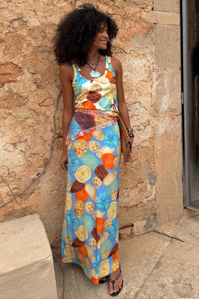Shell Ribbed Skirt with a hand-painted shell print in blue, sand and sunset tones, styled as a summer vacation co-ord.