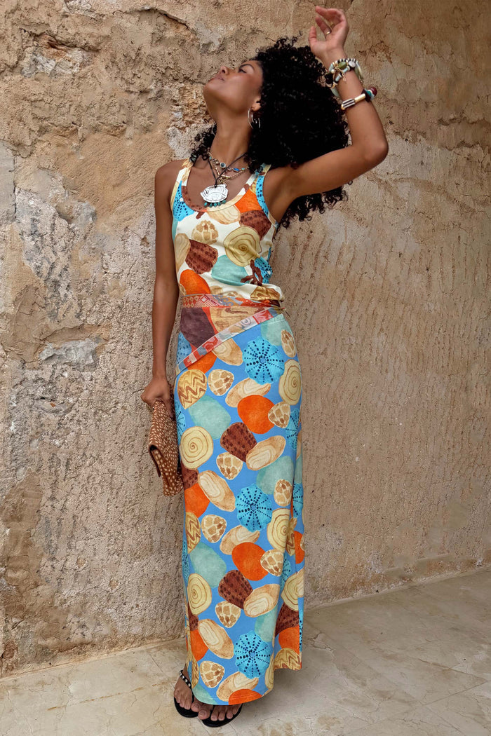 Shell Ribbed Skirt featuring a blue hand-painted shell print in sunset tones and sandy neutrals.
