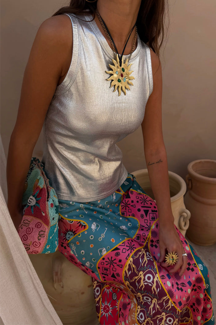 Metallic Silver Ribbed Tank Top paired with a colourful printed skirt and statement sun necklace.