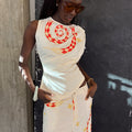 Snake Asymmetric Top in white with a red snake print, star motifs and gathered waist detailing on a model.