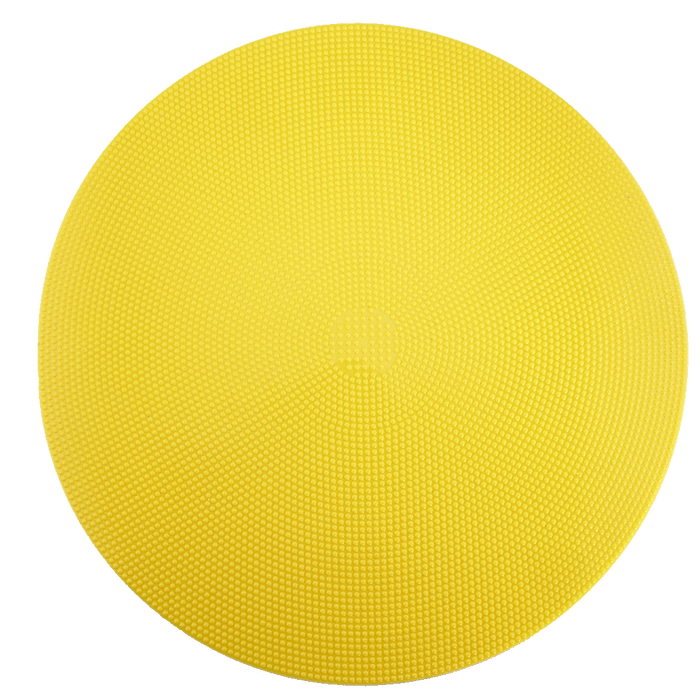A bright yellow, circular disc with a pebbled, non-slip texture on a white background.