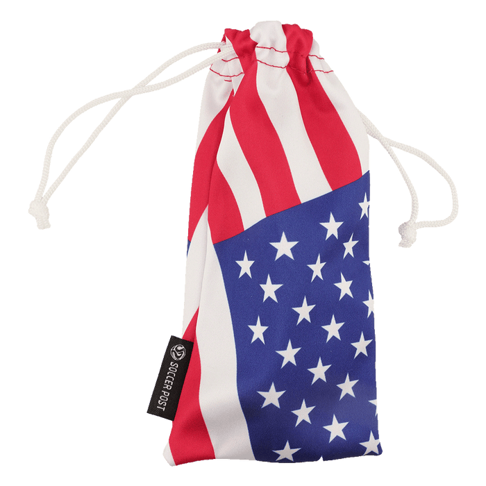 A drawstring pouch featuring a US flag design with red and white stripes on top and white stars on a blue background at the bottom. The pouch has white drawstrings and a black tag on the side that reads "SOCCER POST."