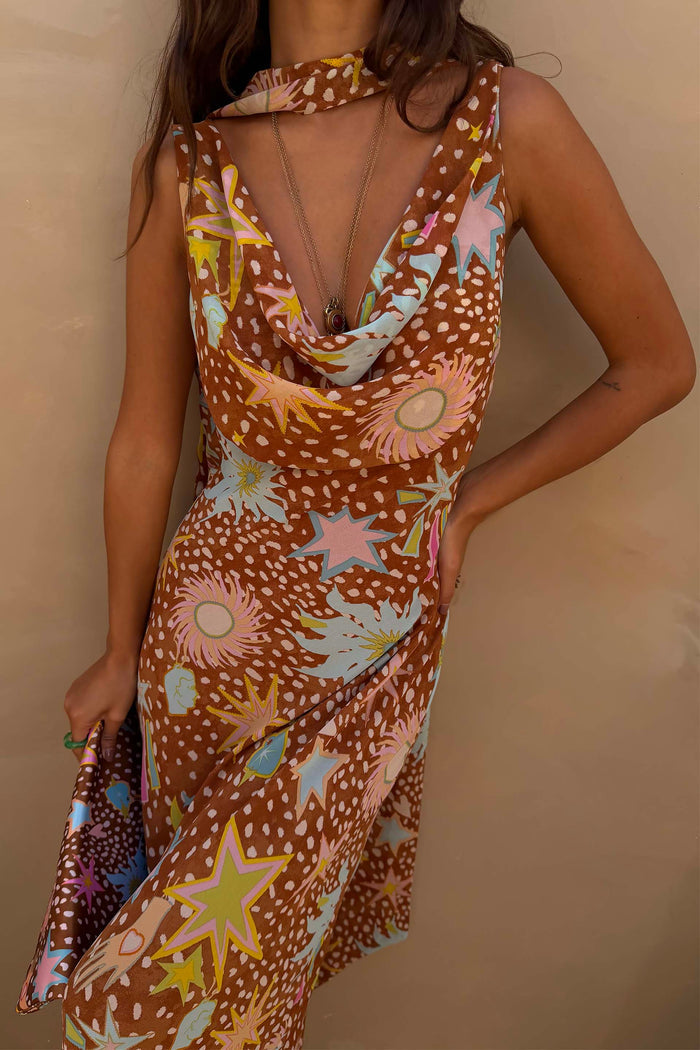 Star Fawn Sophie Dress in brown with star and sun motifs, featuring a draped neck and matching neck scarf.