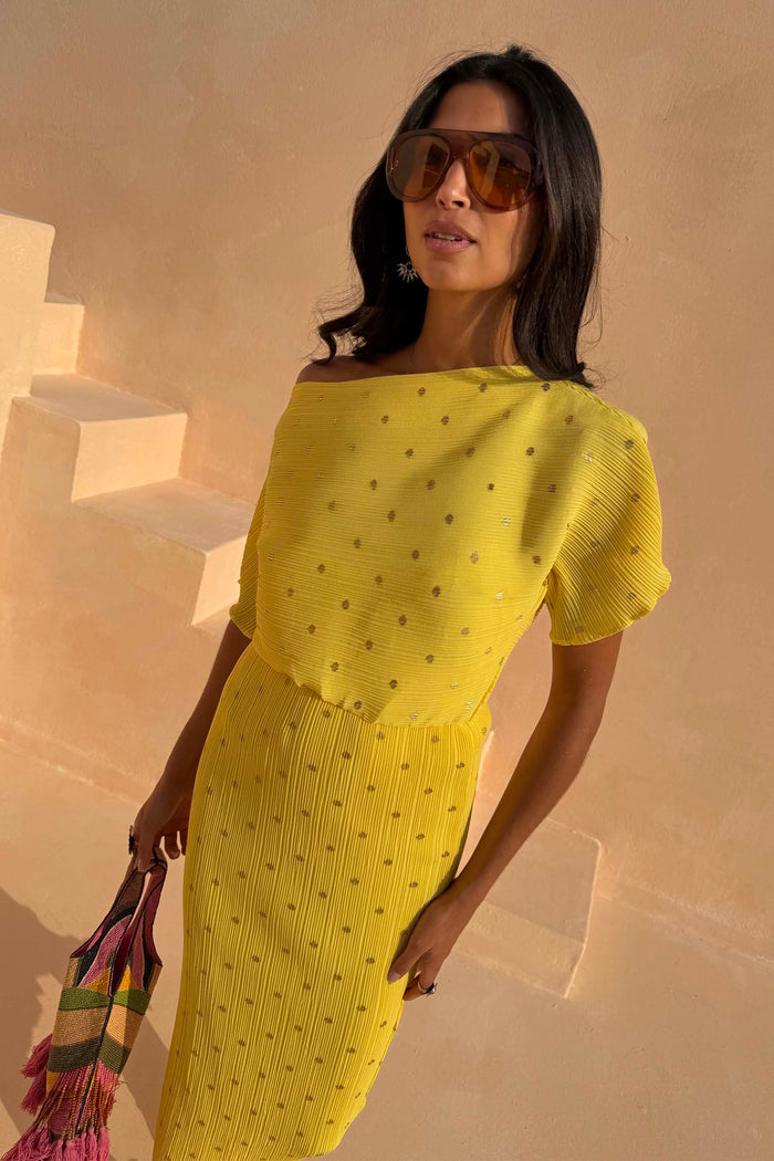 Yellow Sunshine Tilly Dress in plissé fabric with gold flecks and an off-the-shoulder neckline.