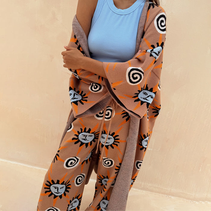 Tan Sun Cardigan with blue sun motifs and wide sleeves, styled as a chic co-ord set with matching trousers.