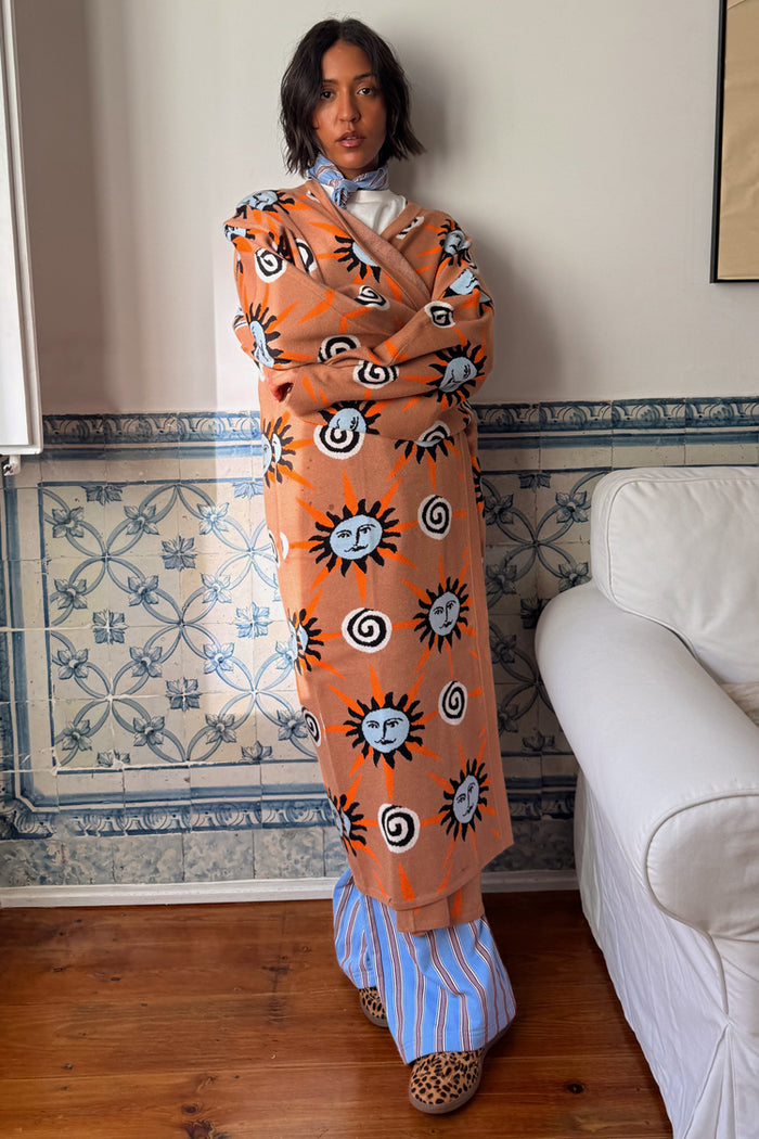 Tan Sun Cardigan with hand-painted sun and swirl motifs in an oversized longline knit silhouette.