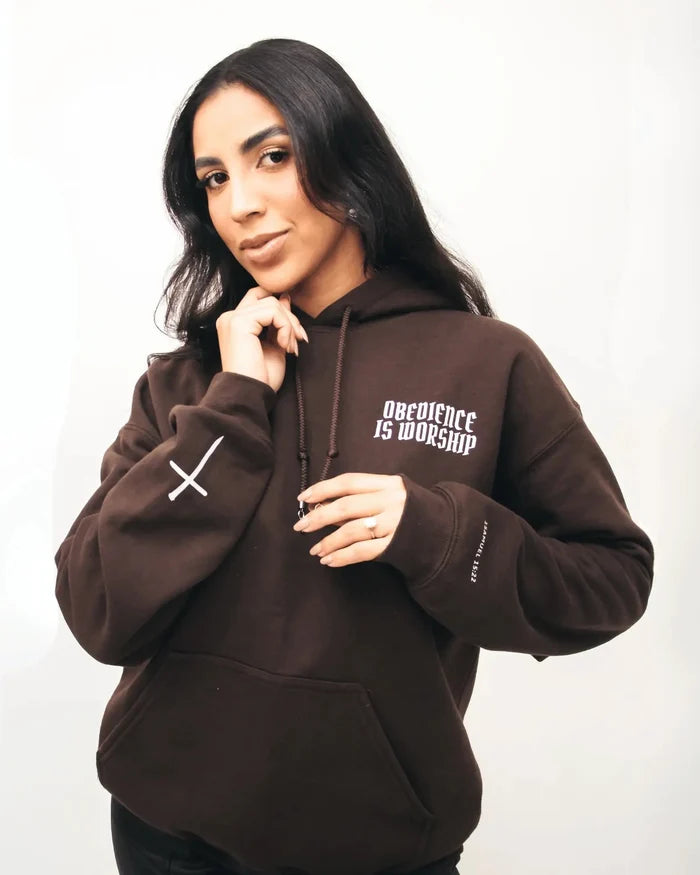 Person wearing a brown hoodie with text on a white background