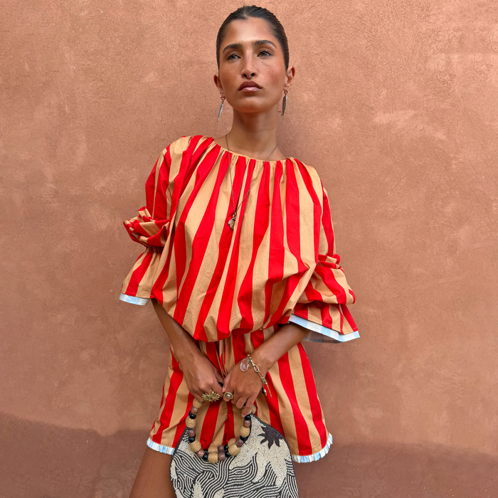 Red and camel Tomato Stripe Blouse with voluminous sleeves, styled as a co-ord with matching shorts.