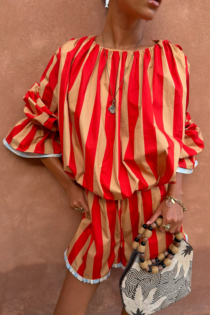 Tomato Stripe Blouse in red and camel stripes with voluminous sleeves and gathered neckline, styled as a vacation co-ord.