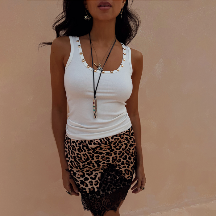 White Studded Rib Vest with gold stud neckline detailing, paired with a leopard print lace-trim skirt.