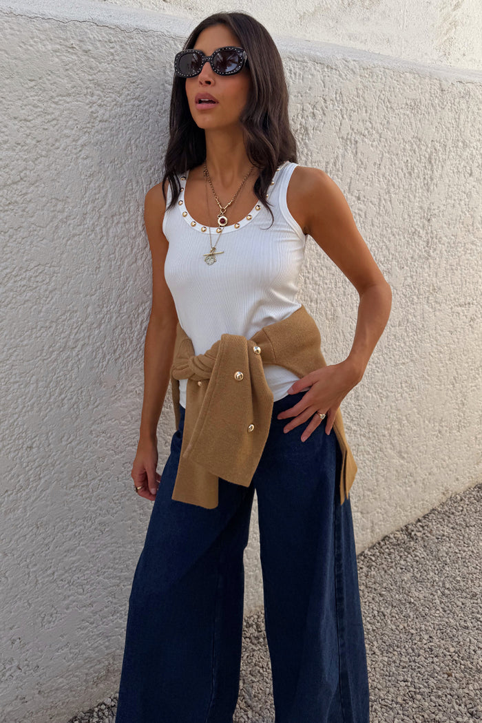 White Studded Rib Vest with gold stud detailing, styled with wide-leg jeans and a camel knit layer.