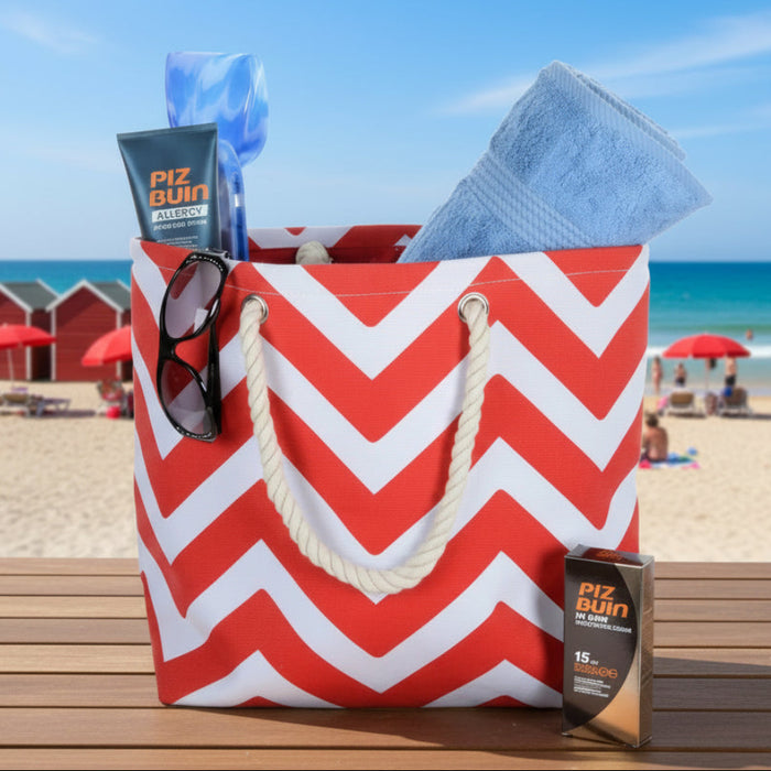 Red and white chevron pattern beach bag with towel on a table at the beach