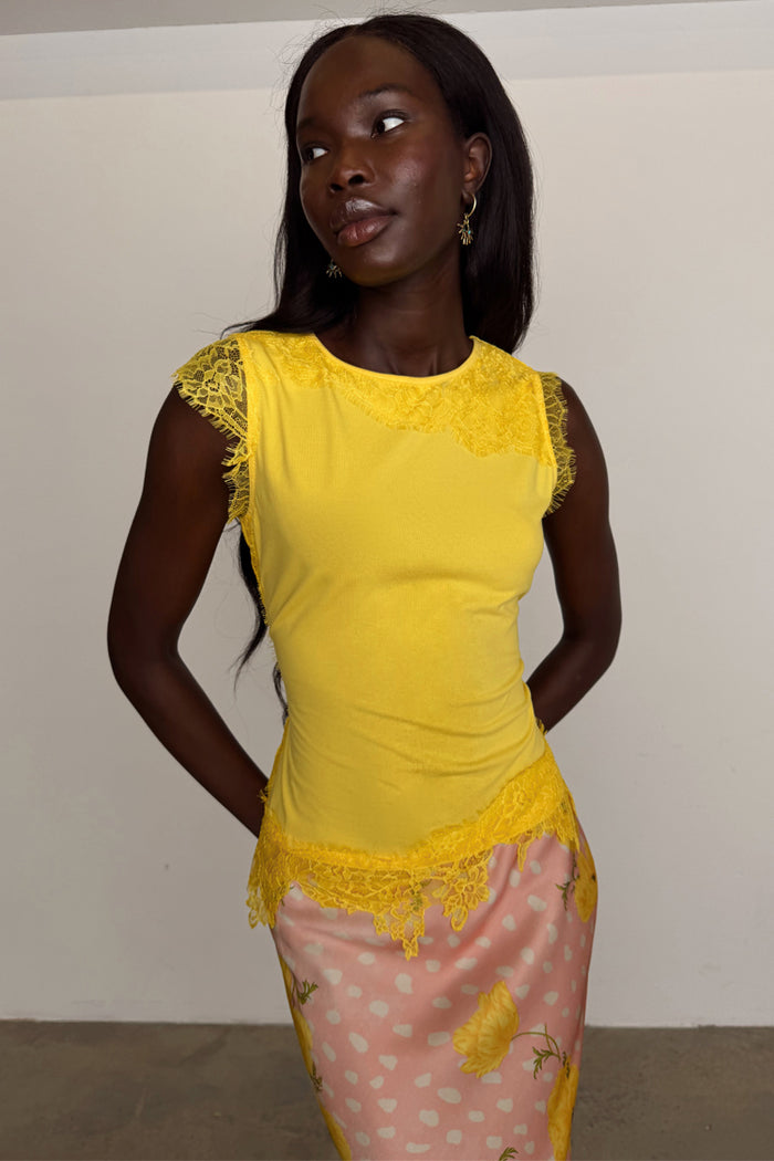 Yellow Lace Insert Top with an asymmetric hem and intricate lace detailing on the sleeves and neckline.