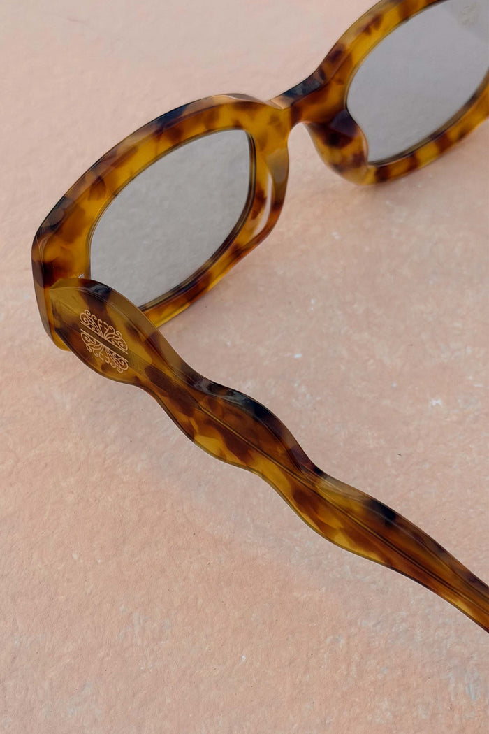 Yellow Tort Wiggle Arm Sunglasses with light blue lenses and a gold NFD logo on the signature wavy arm.